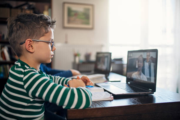 Boy with glasses on computer
